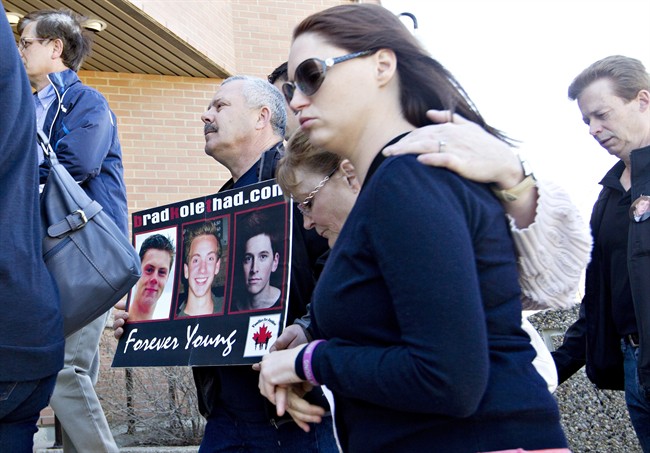 Family members of Bradley Arsenault, 18, Kole Novak, 18, and Thaddeus Lake, 22, make their way to the trial of Jonathan Pratt in Wetaskiwin, Alberta on Monday May 15, 2014. Thirty-year-old Jonathan Pratt has pleaded not guilty to manslaughter, impaired driving and driving over the legal limit relating to a 2011 crash.