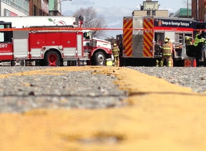 Emergency crews worked to save the lives of two pedestrians struck by a semi-trailer truck in Montreal on May 6, 2014.