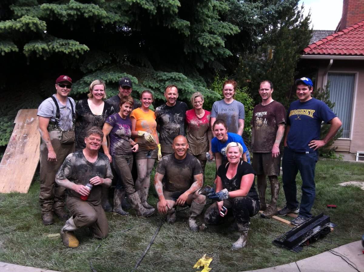 Darcy Verhun (back row, centre) with family members,  friends, and co-workers  who pitched in to help with the flood cleanup at his Rideau Park home in S.W. Calgary.
