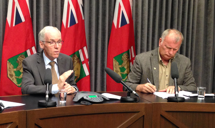 Emergency Measures Minister Steve Ashton, left, and Steve Topping, executive director of hydrologic forecasting and water management, update the media about the flood situation in Manitoba on Wednesday.