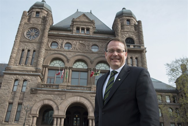 Green Party leader Mike Schreiner poses for a photo in front of the Ontario Legislature in Toronto on Wednesday May 7, 2014. 