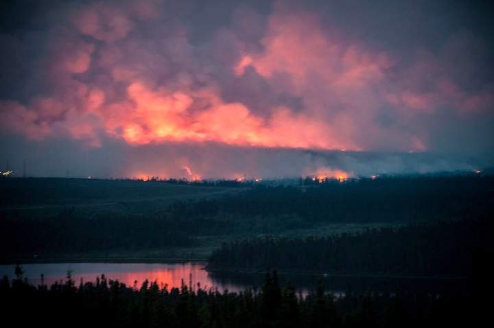 Flames burn on the horizon near Wabush, Newfoundland on Thursday June 27, 2013.