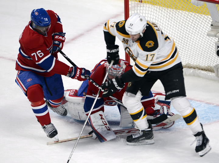 Boston Bruins left wing Milan Lucic (17) battles for the puck with Montreal Canadiens defenseman P.K. Subban (76) in front of Montreal Canadiens goalie Carey Price (31) during third period NHL playoff hockey action Thursday, May 8, 2014 in Montreal. 
