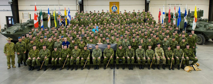 Courageous Companions service dog Hank, pictured with Cpl. Johnny Langevin and his regiment.