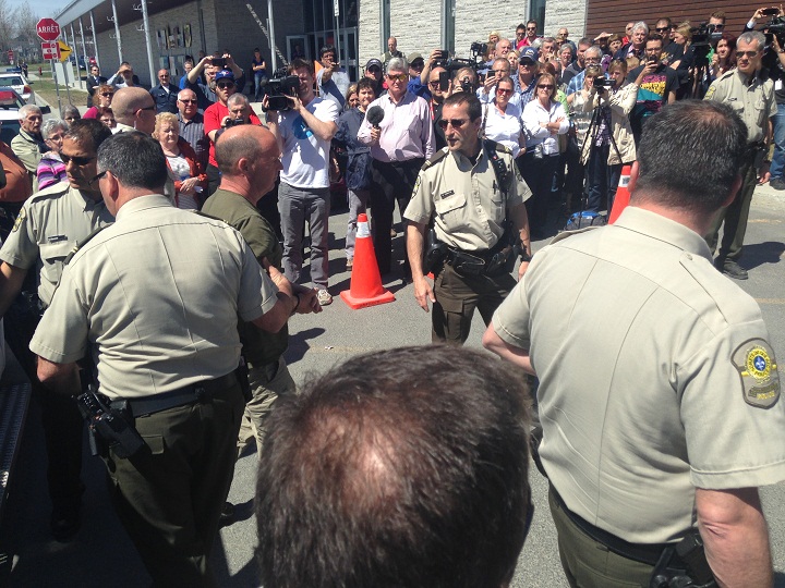Three former Montreal Maine and Atlantic Railway Ltd. employees were escorted by police to appear in court in Lac-Megantic, Que., on Tuesday, May 13, 2014.