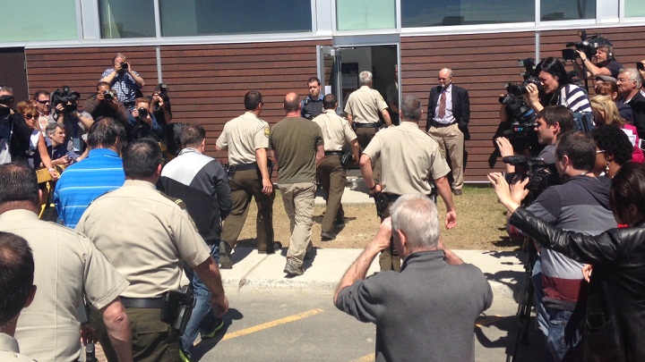 Three former Montreal Maine and Atlantic Railway Ltd. employees were escorted by police to appear in court in Lac-Megantic, Que., on Tuesday, May 13, 2014.