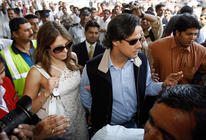 British model and actress Elizabeth Hurley (2L) and her husband Indian businessman Arun Nayar (C) are accompanied by security personnel as they leave Chattrapati Shivaji International airport in Mumbai, 05 March 2007. Hurley, 41, married Nayar, 42, 02 March, in a private ceremony at Sudeley Castle in southwest England a day ahead of a star-studded event.
