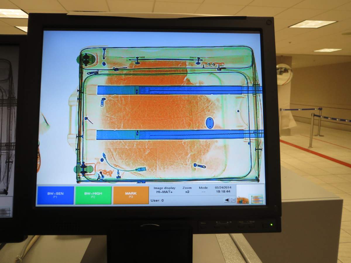 Seized suspected heroin and false bottom suitcase used to conceal the narcotics.