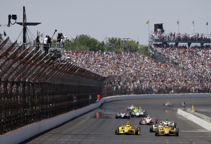 Ryan Hunter-Reay celebrates as he takes the checkered flag to win  the 98th running of the Indianapolis 500 IndyCar auto race at the Indianapolis Motor Speedway in Indianapolis, Sunday, May 25, 2014. 