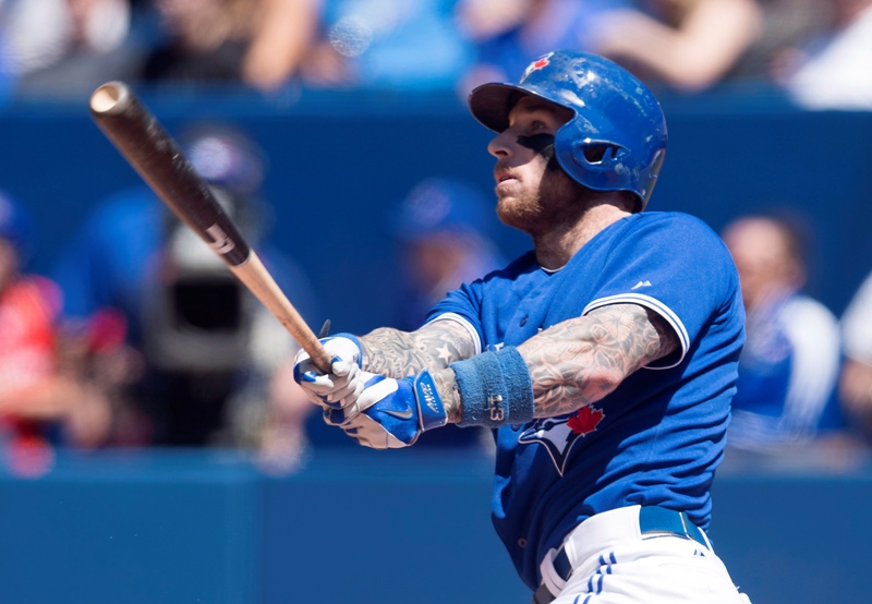 Toronto Blue Jays' Brett Lawrie hits a solo home run in the fifth inning of MLB baseball action against the Oakland Athletics in Toronto on Saturday, May 24, 2014. THE CANADIAN PRESS/Darren Calabrese.