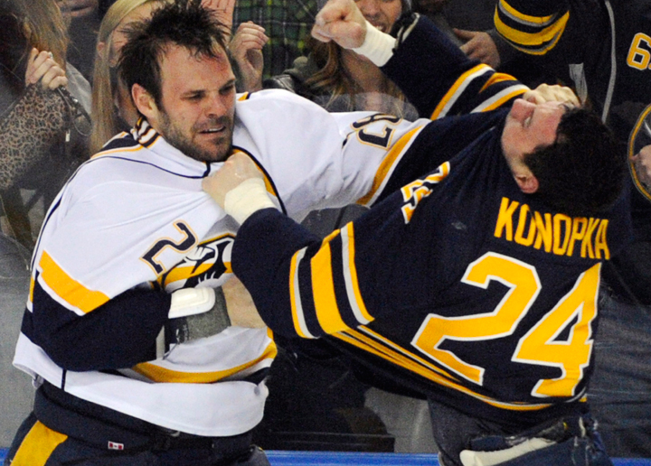 Nashville Predators' Paul Gaustad (28) pushes the jersey into the face of Buffalo Sabres' Zenon Konopka (24) as he throws a punch during a fight in the second period of an NHL hockey game in Buffalo, N.Y., Tuesday, March 11, 2014. 
