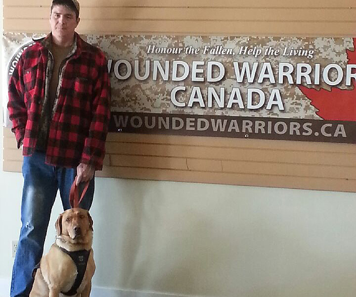 Cpl. Johnny Langevin pictured with his service dog Hank.