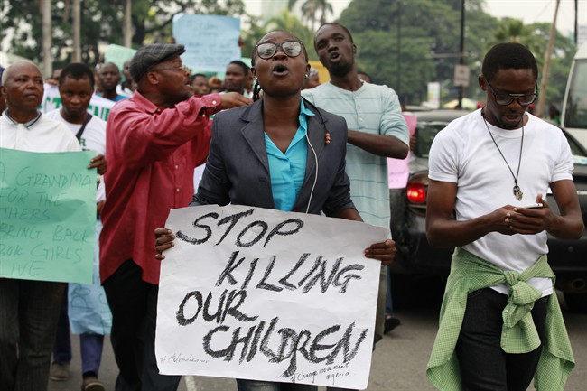 People attend a demonstration calling on government to rescue kidnapped school girls of a government secondary school Chibok, during workers day celebration in Lagos, Nigeria. Thursday, May, 1. 2014,.