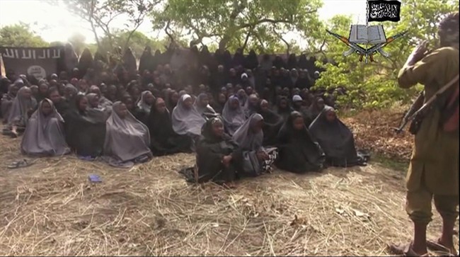 In this photo taken from video by Nigeria's Boko Haram terrorist network, Monday May 12, 2014 shows the alleged missing girls abducted from the northeastern town of Chibok. The new video purports to show dozens of abducted schoolgirls, covered in jihab and praying in Arabic. It is the first public sight of the girls since more than 300 were kidnapped from a northeastern school the night of April 14 exactly four weeks ago.