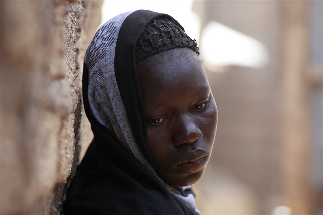 In this photo taken Monday, May 19, 2014, Solome Ishaya, sister of kidnapped school girls Hauwa Ishaya stands outside their family house in Chibok, Nigeria.