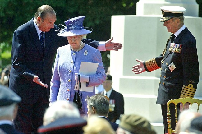 In this June 6, 2004 file photo, French President Jacques Chirac greets Queen Elizabeth II and her husband Prince Philip at the British military cemetery in Bayeux, northwestern France, during ceremonies marking the 60th anniversary of the D-Day landings in Normandy. 
