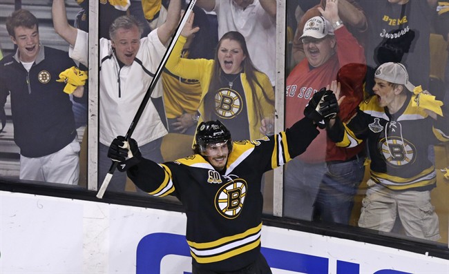 Boston Bruins left wing Loui Eriksson (21) celebrates his goal against Montreal Canadiens goalie Carey Price during the third period of Game 5 in the second-round of the Stanley Cup hockey playoff series in Boston, Saturday, May 10, 2014. 