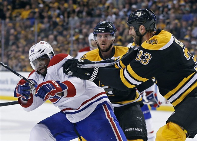 Boston Bruins defenseman Zdeno Chara (33) tries to move Montreal Canadiens defenseman P.K. Subban (76) off the puck as Bruins center David Krejci, middle, looks on during the second period in Game 2 of an NHL hockey second-round playoff series in Boston, Saturday, May 3, 2014. 