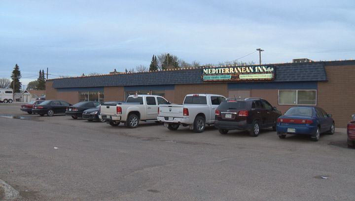 Two men overpowered an armed robbery suspect at a Saskatoon restaurant, but not before she bit one victim.