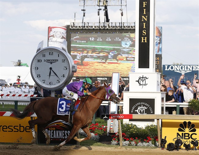 California Chrome, ridden by jockey Victor Espinoza, wins the 139th Preakness Stakes horse race at Pimlico Race Course, Saturday, May 17, 2014, in Baltimore.