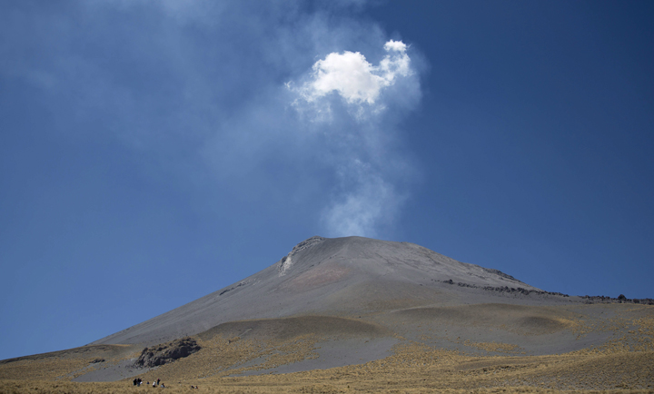 People who live in nearby villages make their yearly pilgrimage up the slopes of the Popocatepetl volcano in Mexico, Wednesday, March 12, 2014.