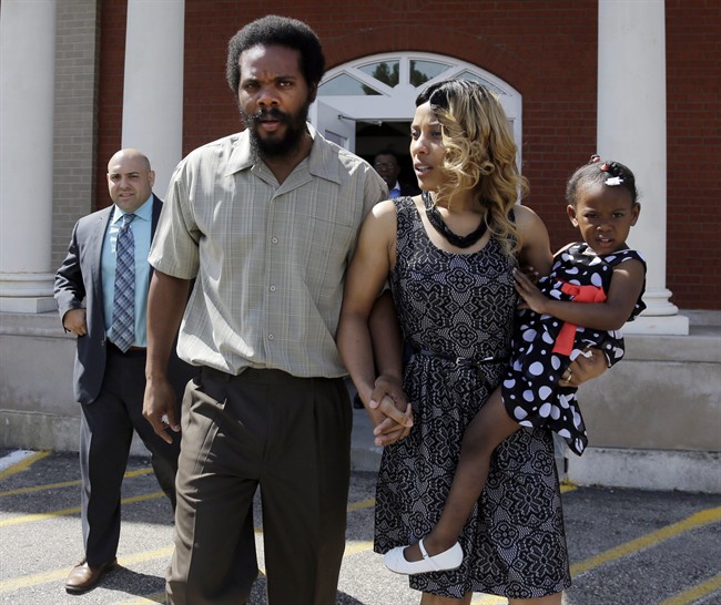 Cornealious "Mike" Anderson walks out of the Mississippi County Courthouse along with his wife, LaQonna Anderson, daughter Nevaeh, 3, and attorney Patrick Megaro, far left, after being released from custody, Monday, May 5, 2014, in Charleston, Mo.