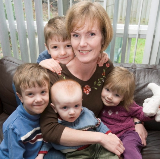 Claire Johnson is shown at her Mississauga, Ont. home on Friday May 2, 2008 with her children Natalie (right) age 2, Evan (on lap) 8 months, and five-year-old twins Byron (left) and Brock (over her shoulder). THE CANADIAN PRESS/Frank Gunn.