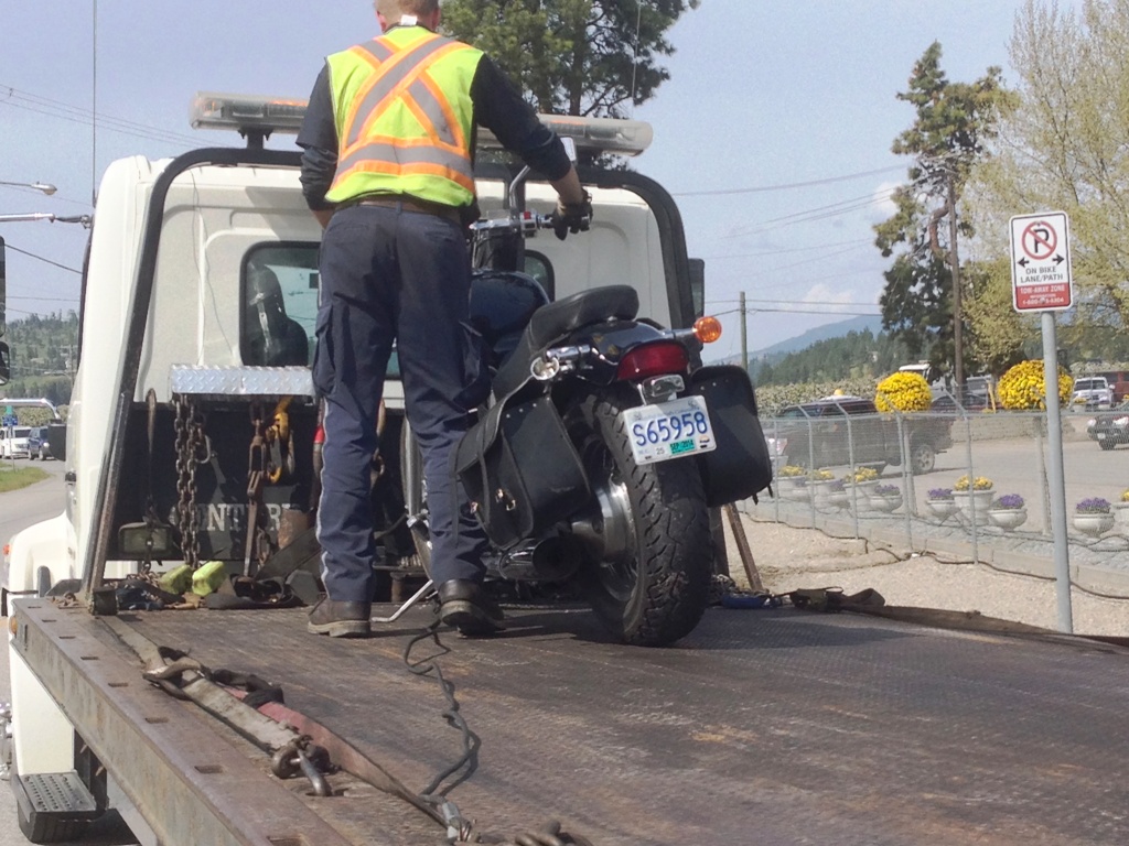 A motorcycle is placed on a flatbed after it was damaged in a crash near Dilworth Drive Thursday. 