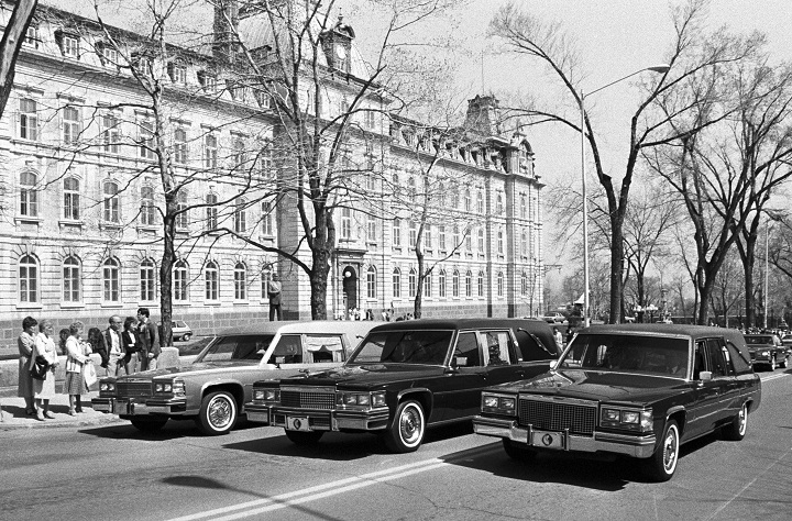 The hearses of three civil servants stand in front of the Quebec National Assembly building in Quebec City on May 11, 1984.
