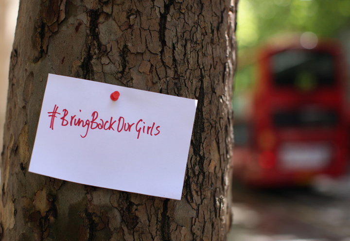 A sign that reads 'Bring back our girls' is pinned to a tree as Protesters calling for the release of a group of abducted Nigerian schoolgirls gather outside Nigeria House on May 9, 2014 in London, England. 