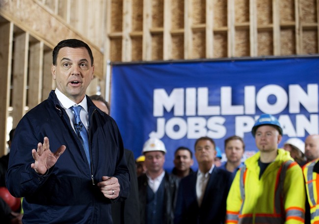 Ontario PC leader Tim Hudak speaks with trade workers at a hew housing development during a campaign stop promising to create 200,000 new skilled trade jobs in Vaughan, Ont., on Thursday, May 8, 2014. THE CANADIAN PRESS/Nathan Denette.
