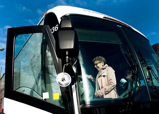 Liberal Leader Kathleen Wynne walks of her campaign bus in Toronto on Tuesday, May 6, 2014. THE .