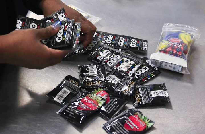 In an Friday April 25, 2014 file photo, an outreach worker at Boom Health center package condoms for distribution to sex trade workers,in Bronx, N.Y. 