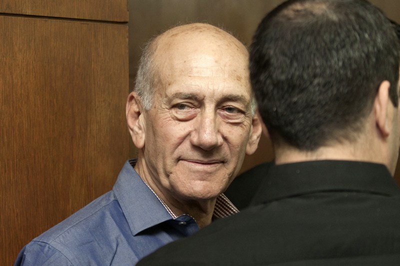 Former Israeli Prime Minister Ehud Olmert waits before the start of a hearing in his trial for corruption linked to a major property development on March 31, 2014 at Tel Aviv District Court. The court found Olmert guilty of bribery linked to the construction of the massive Holyland residential complex when he served as the city's mayor, in one of the worst corruption scandals in Israeli history. AFP PHOTO / POOL / DAN BALILTY.