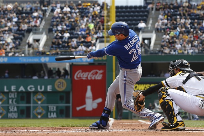 Toronto Blue Jays' Colby Rasmus, left, hits a grand slam in front of Pittsburgh Pirates catcher Chris Stewart in the second inning of the baseball game on Sunday, May 4, 2014, in Pittsburgh. (AP Photo/Keith Srakocic).