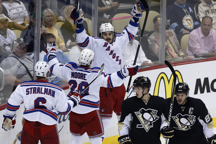 New York Rangers' Brian Boyle (22) celebrates his goal with teammates Anton Stralman (6) and Dominic Moore as Pittsburgh Penguins' Sidney Crosby (87) and Olli Maatta (3) skate back to their bench in the first period of Game 7 of a second-round NHL playoff hockey series, in Pittsburgh on Tuesday, May 13, 2014. 