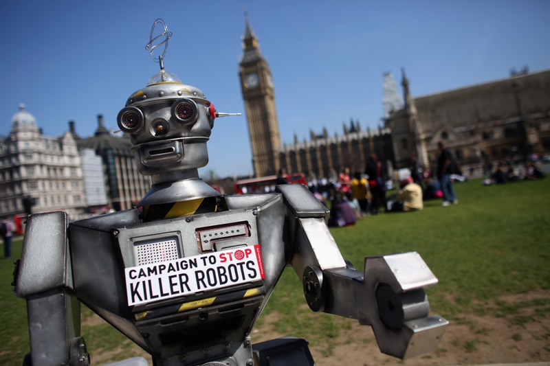 A robot distributes promotional literature calling for a ban on fully autonomous weapons in Parliament Square on April 23, 2013 in London, England. The 'Campaign to Stop Killer Robots' is calling for a pre-emptive ban on lethal robot weapons that could attack targets without human intervention. (Photo by Oli Scarff/Getty Images).