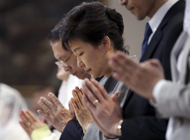 South Korean President Park Geun-hye prays during a serves to pay tribute to victims of the sunken ferry Sewol at a Catholic church in Seoul, South Korea, Sunday, May 18, 2014. 