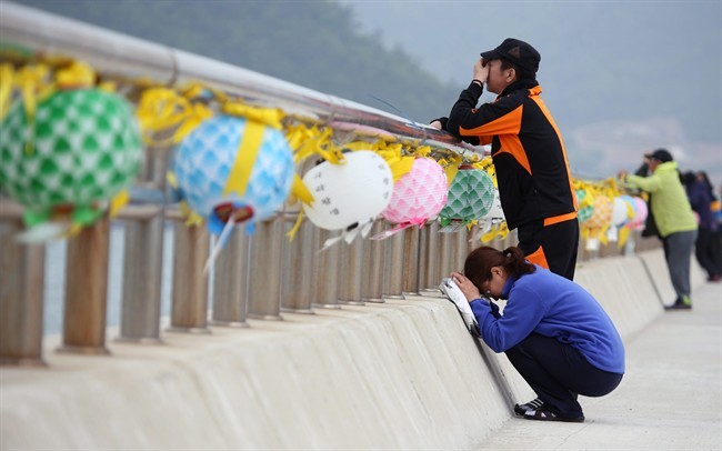 Relatives of a passenger aboard the sunken ferry Sewol weep at a port in Jindo, South Korea, Thursday, May 8, 2014. 
