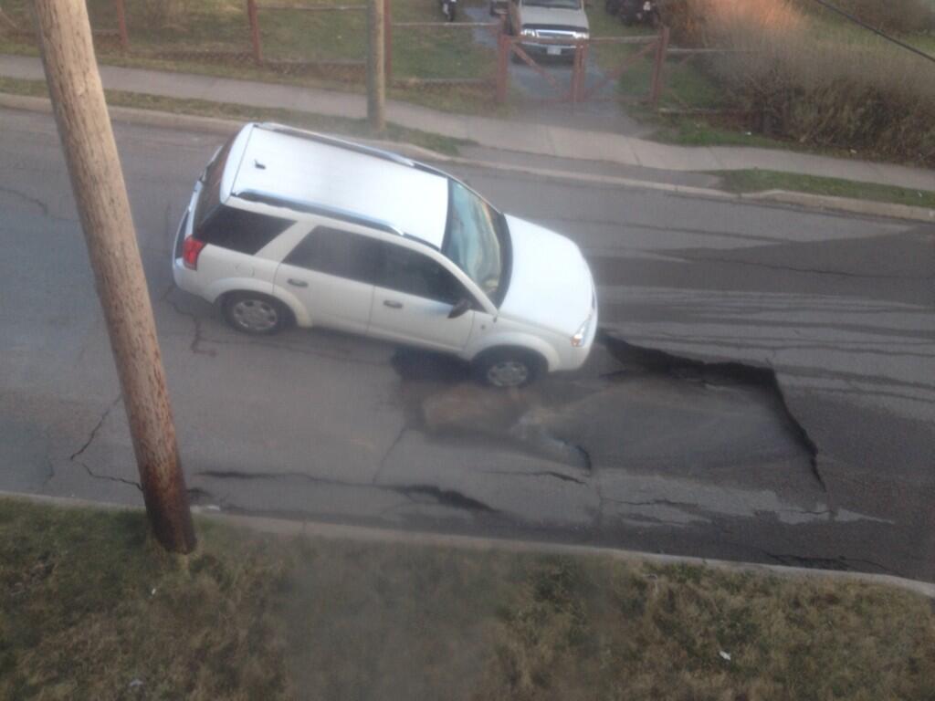A car is trapped in a sinkhole that opened up on Rodney Street in Saint John.