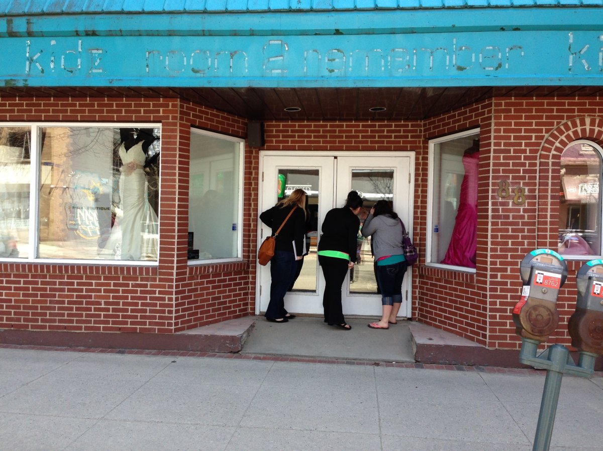 Brides-to-be look inside a closed bridal boutique in Fredericton. 