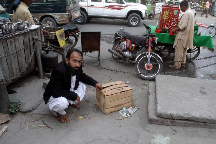 Mustafa Kharal, lawyer of pregnant woman Farzana Parveen who was stoned to death, shows the area where she was killed in Lahore, Pakistan, Wednesday, May 28, 2014.  