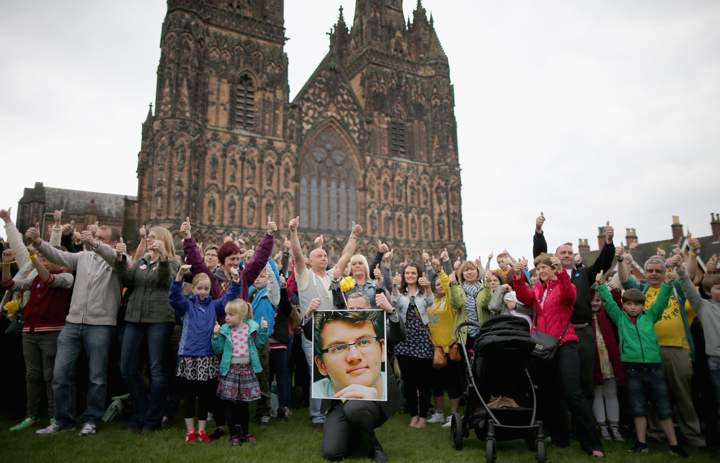 Members of the public take part in a minute of celebration and give the ‘thumbs up’ sign for the life of teenage cancer fundraiser Stephen Sutton during a vigil at Lichfield Cathedral on May 30, 2014 in Lichfield, England.