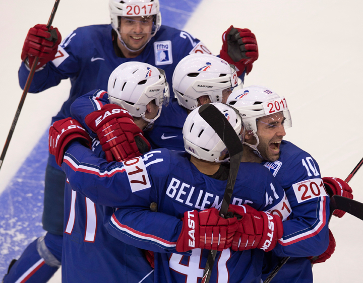 Team France captain Laurent Meunier, right, and players gather around Pierre-Edouard Bellemare, centre, after he scored the winning goal in a shootout Friday, May 9, 2014 at the IIHF World Hockey Championship in Minsk, Belarus.