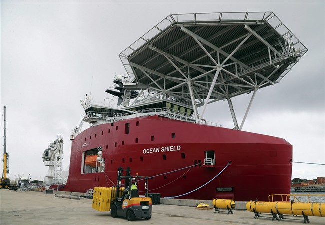 In this March 30, 2014 file photo, Australian Defense ship Ocean Shield is docked at naval base HMAS Stirling while being fitted with an autonomous underwater vehicle (AUV) and towed pinger locator to aid in the search for missing Malaysia Airlines Flight MH370, in Perth, Australia.  (AP Photo/Rob Griffith, File).