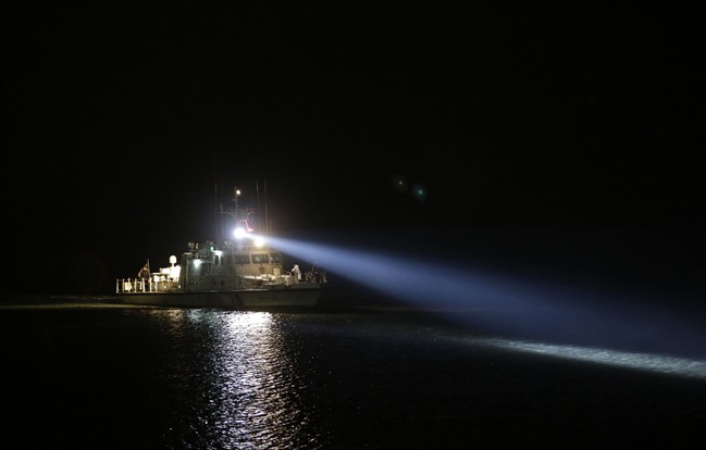 In this April 19, 2014 file photo, a South Korea Coast Guard boat carrying three bodies of passengers aboard the sunken ferry Sewol arrives at a port in Jindo, south of Seoul, South Korea. 