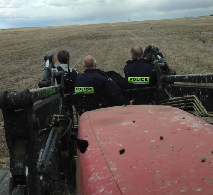 Tractor carrying RCMP officers while searching for three car thieves near Briercrest, Saskatchewan.