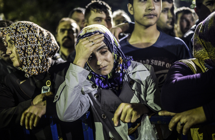 People stand in front of a hospital in Soma.