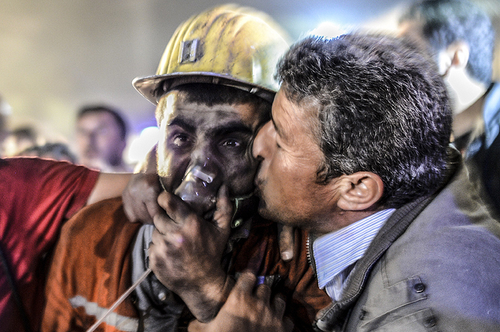 A man kisses his son, rescued of the mine, on May 13, 2014 after an explosion in a coal mine in Manisa. At least 157 miners were killed in collapsed coal mine in the western Turkish city of Manisa.