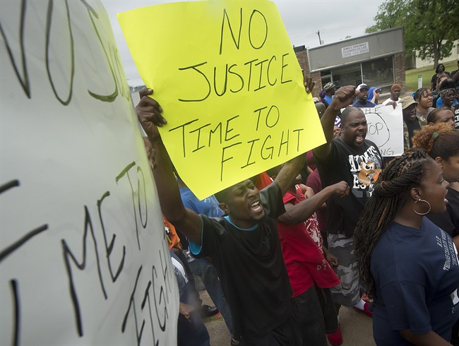 Protesters chant during a rally outside the Hearne, Texas police department Thursday, May 8, 2014 following the Tuesday shooting of 93-year-old woman. 